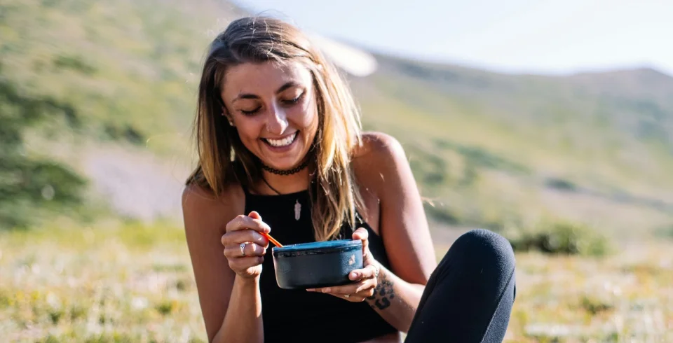 a woman sitting on a hill