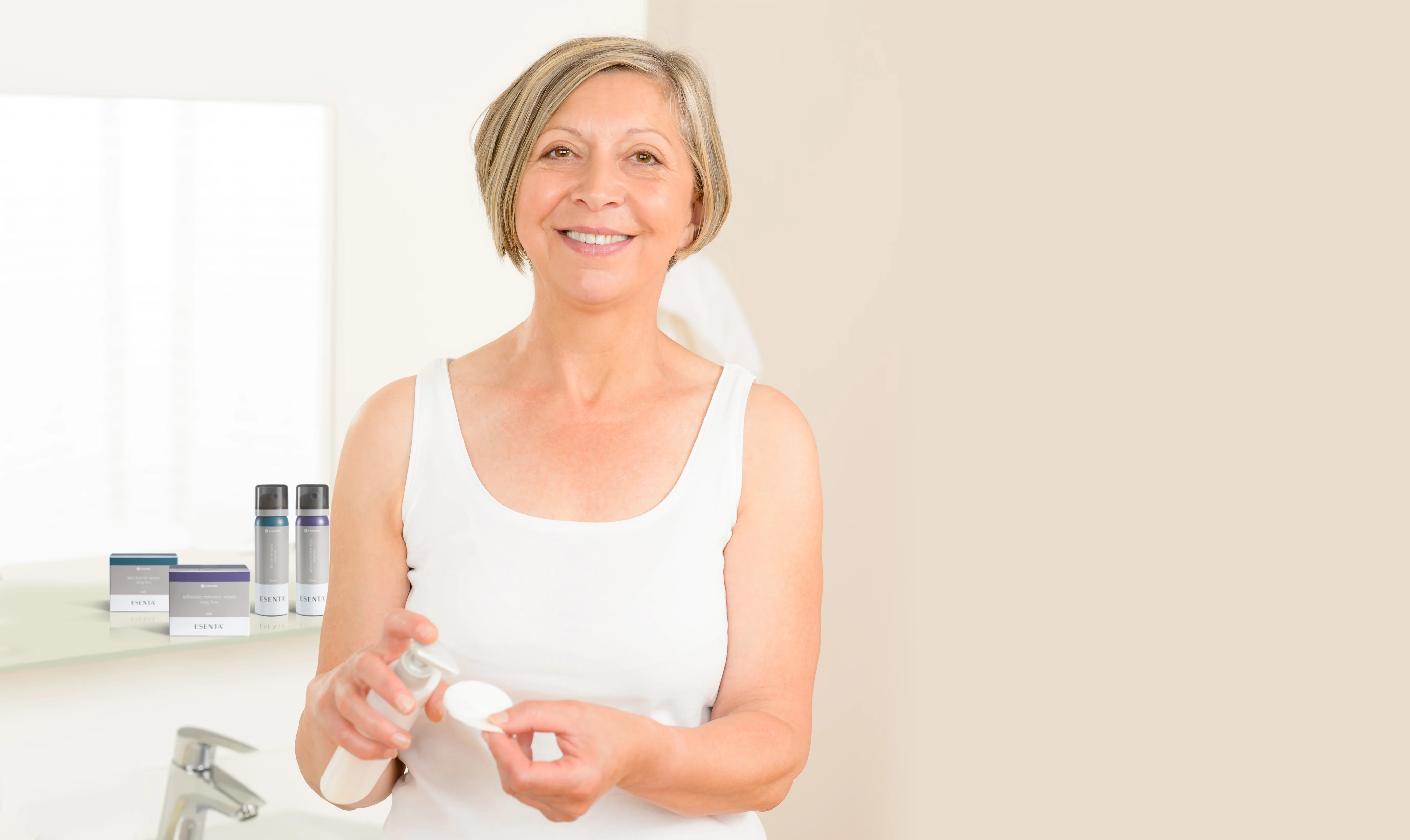 a woman smiling and holding a bottle