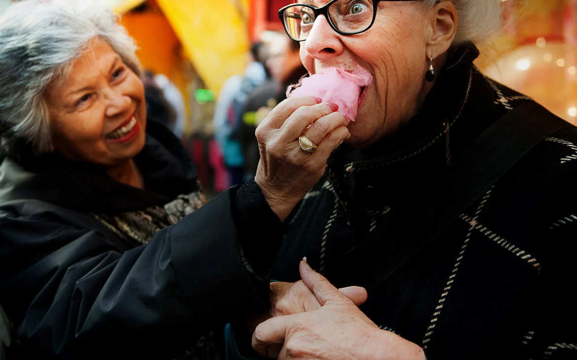 two women eating candy floss