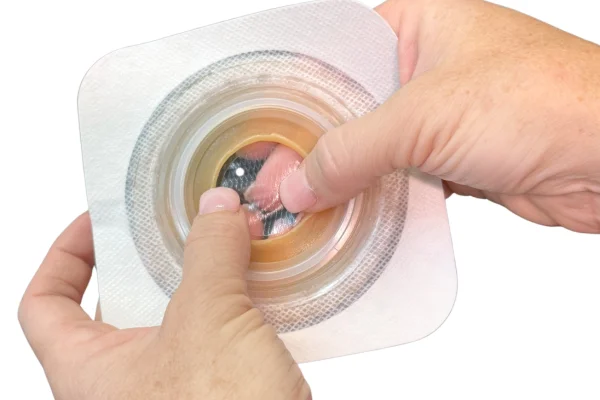 a person holding a small white container