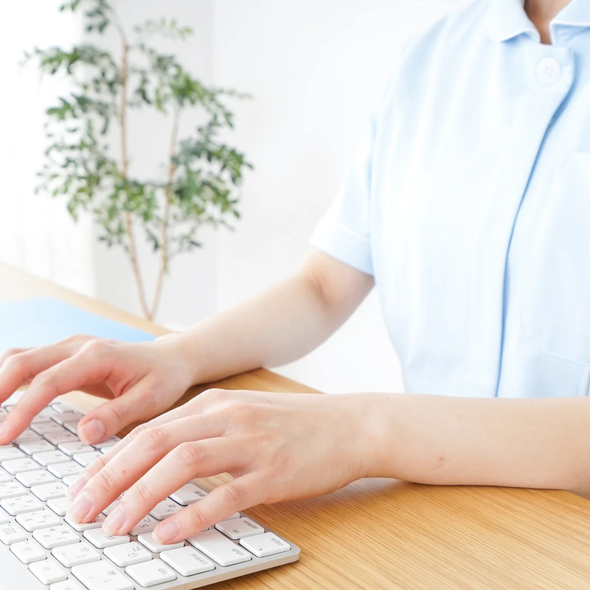 A close-up of a person typing on a keyboard.