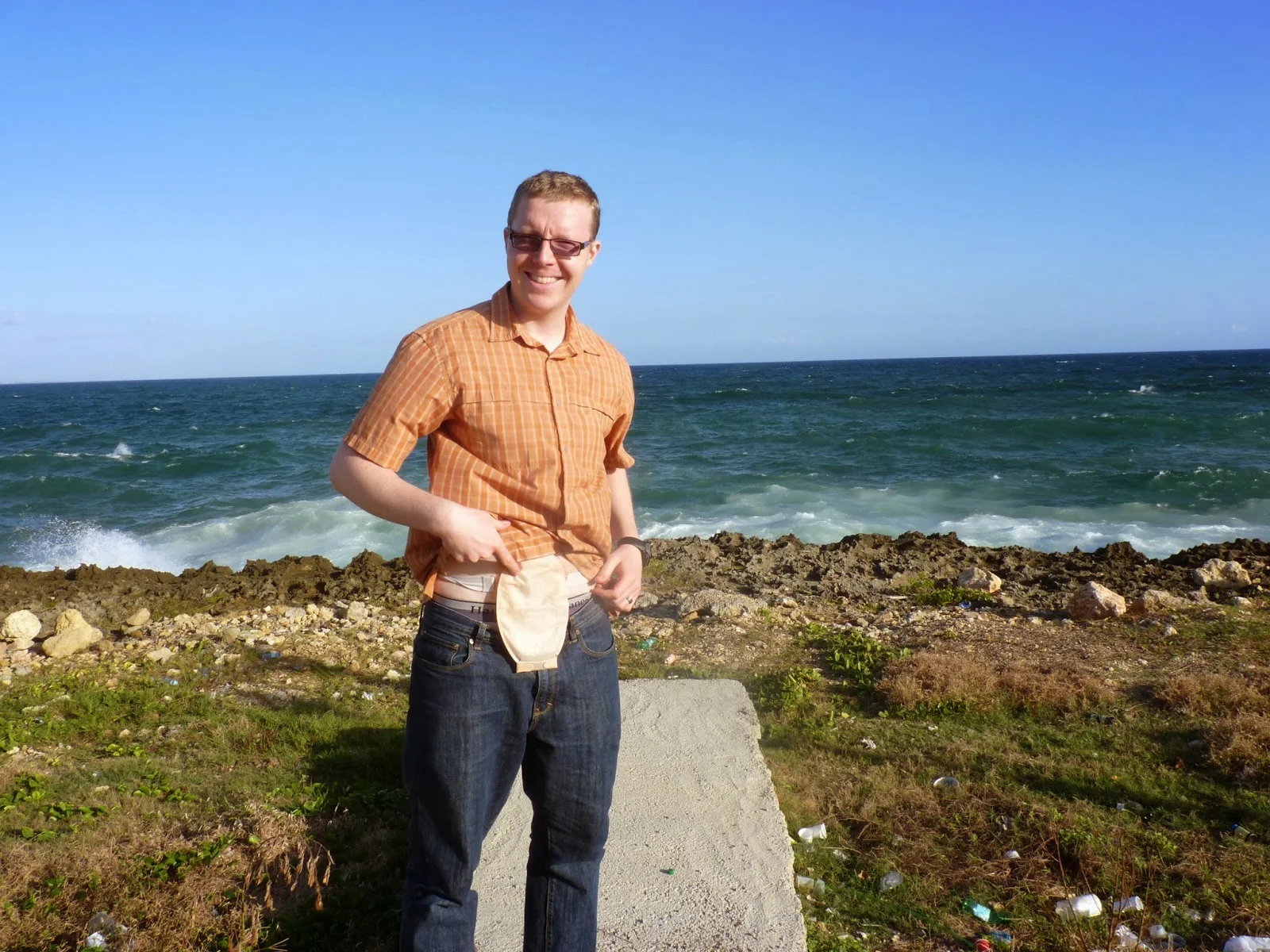 a man standing on a rock by the water